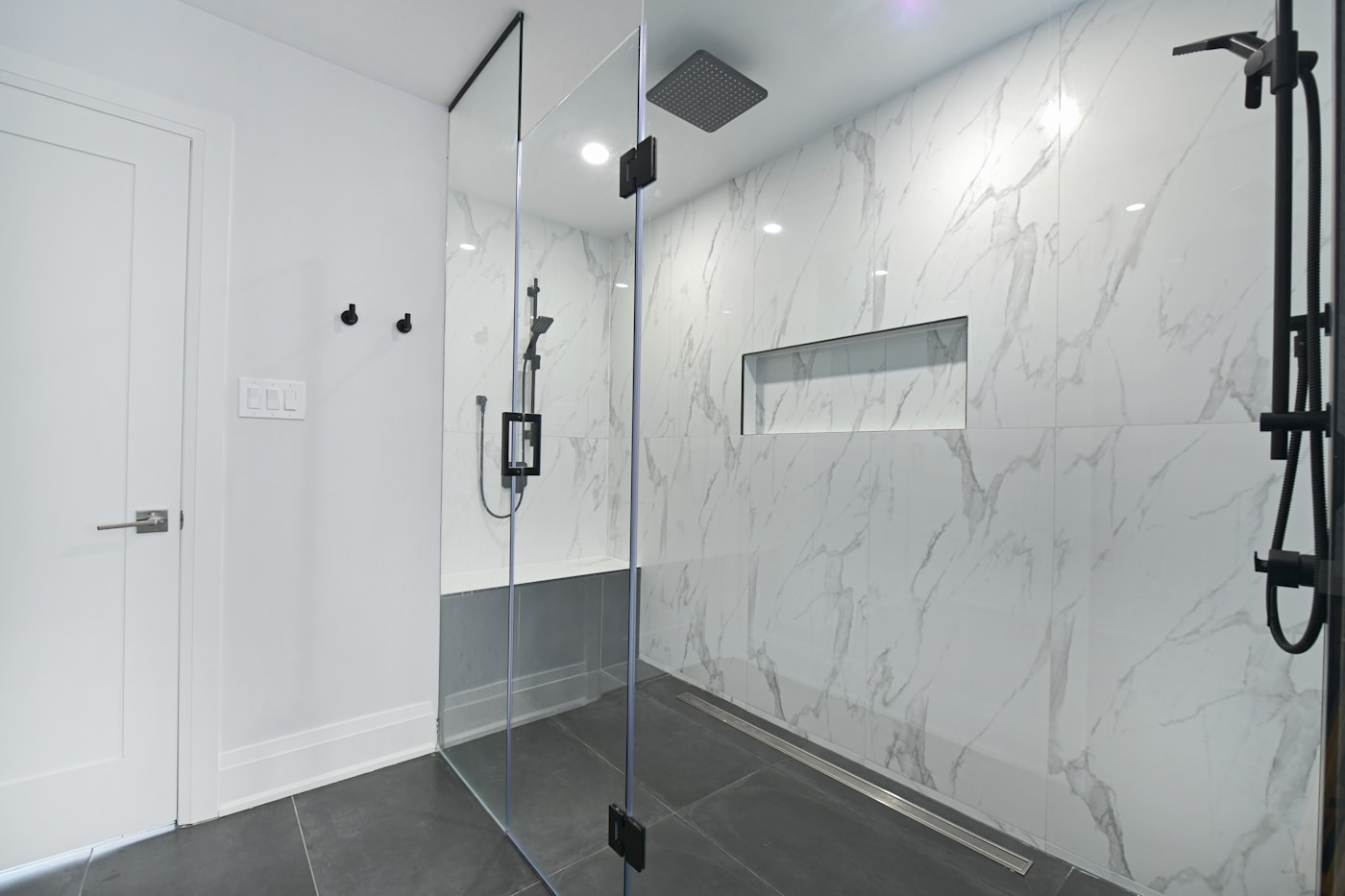 A walk-in shower with marble tiling, fitted by us